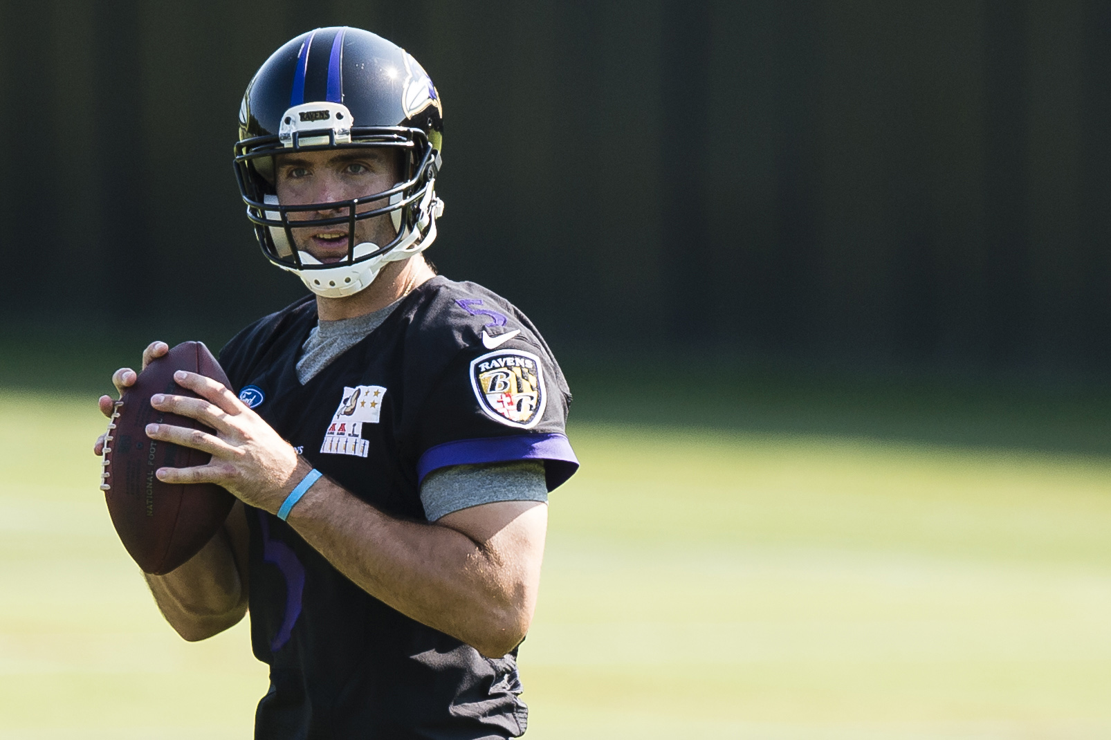 Baltimore Ravens QB Joe Flacco (5) drops back to pass in the first